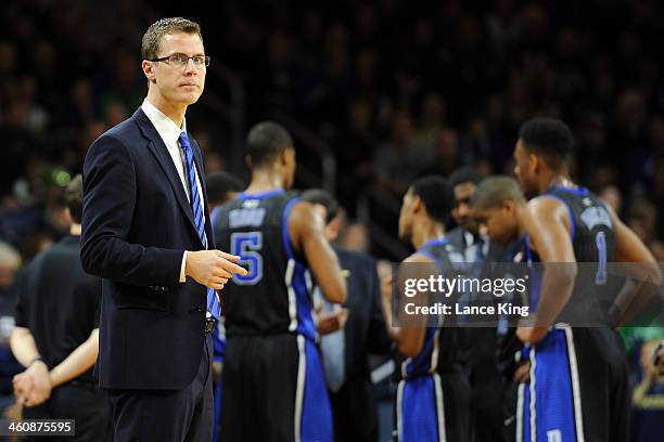 Special Assistant Jon Scheyer of the Duke Blue Devils looks on during a stop in play against the Notre Dame Fighting Irish at Purcell Pavilion at the...