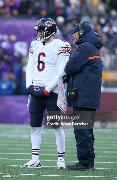 Jay Cutler and head coach Marc Trestman of the Chicago Bears talk during a timeout in the fourth quarter on December 28, 2014 at TCF Bank Stadium in...