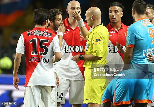 Joao Moutinho of Monaco receives a yellow card from referee Tony Chapron during the French Ligue 1 match between AS Monaco FC v Olympique de...
