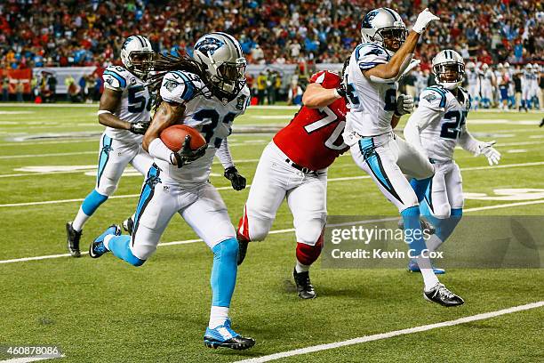 Tre Boston of the Carolina Panthers returns an interception for a touchdown in the second half against the Atlanta Falcons at the Georgia Dome on...