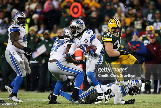 Rashean Mathis of the Detroit Lions carries a ball that was ruled down after a completion to Eddie Lacy of the Green Bay Packers in the third quarter...