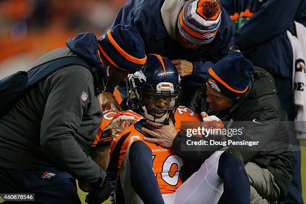 Strong safety David Bruton of the Denver Broncos is attended to by trainers after a play that would force him out of the game with a reported...