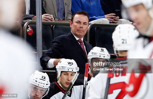 Co-coach Adam Oates of the New Jersey Devils follows the action from the bench against the New York Rangers at Madison Square Garden on December 27,...