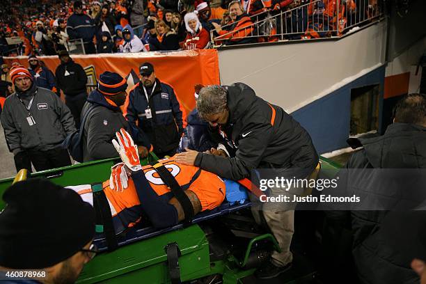 Strong safety David Bruton of the Denver Broncos is carted off the field after suffering a reported concussion during a game against the Oakland...