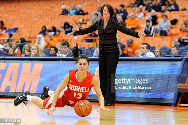 Christine Kline falls on the court as head coach Dayna Smith of the Cornell Big Red reacts on the sidelines during the second half at the Carrier...