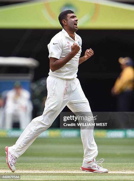 Indian spinner Ravi Ashwin celebrates after dismissing Australian batsman David Warner during the fourth day of the third cricket Test match against...