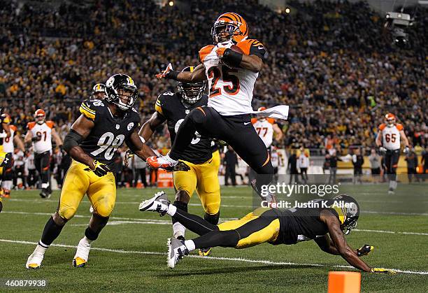 Giovani Bernard of the Cincinnati Bengals hurdles over William Gay of the Pittsburgh Steelers and scores a touchdown during the first quarter at...