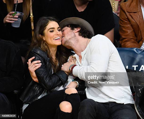 Ian Somerhalder and Nikki Reed kiss at a basketball game between the Phoenix Suns and the Los Angeles Lakers at Staples Center on December 28, 2014...