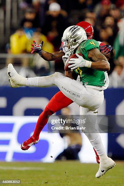 Defensive back Erick Dargan of the Oregon Ducks pulls down an interception for a 24-yard return on a pass intended for wide receiver Samajie Grant of...