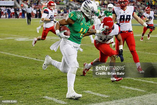Erick Dargan of the Oregon Ducks returns a punt as he is pushed out of bounds by Blake Brady of the Arizona Wildcats in the fourth quarter on...