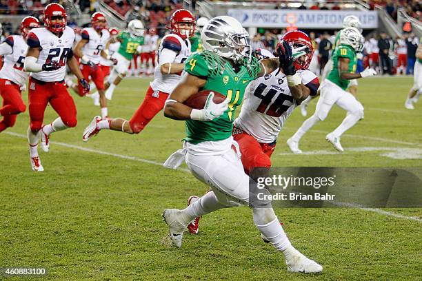 Erick Dargan of the Oregon Ducks returns a punt as he is caught by Blake Brady of the Arizona Wildcats in the fourth quarter on December 5, 2014...