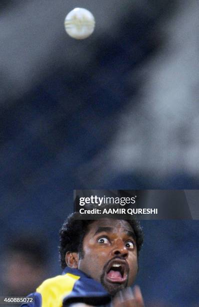 Sri Lankan cricketer Muttiah Muralitharan delivers the ball during a team training session at the Gaddafi Cricket Stadium in Lahore on January 23,...