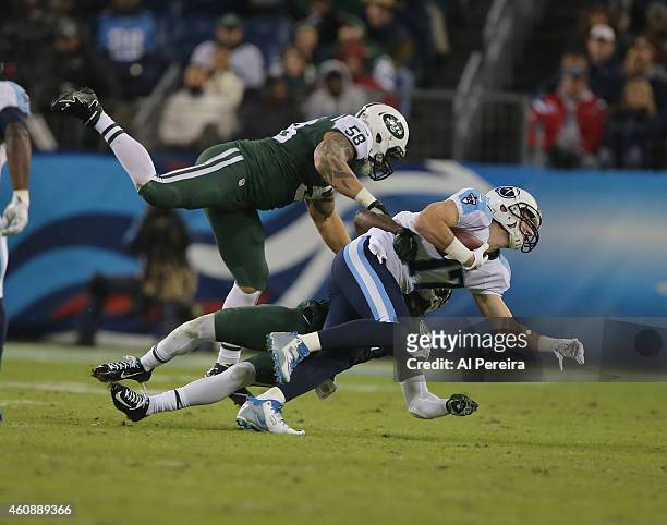 Linebacker Jason Babin of the New York Jets makes a stop against the Tennessee Titans at LP Field on December 14, 2014 in Nashville, Tennessee.