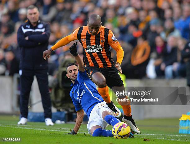 Sone Aluko of Hull City is tackled by Riyad Mahrez of Leicester City during the Barclays Premier League match between Hull City and Leicester City at...
