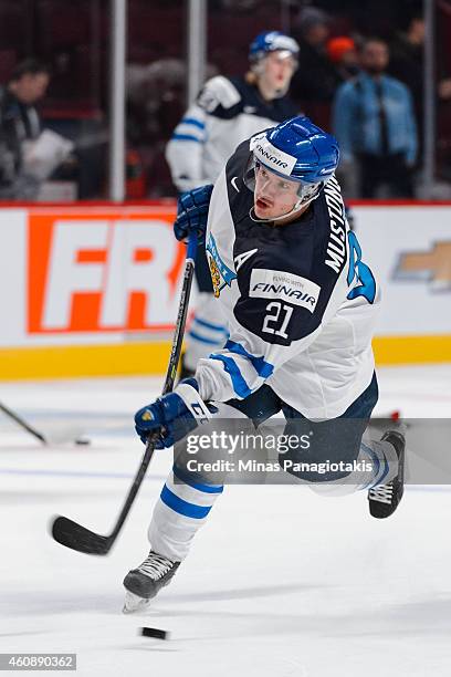 Aleksi Mustonen of Team Finland takes a shot during the warmup period prior to the 2015 IIHF World Junior Hockey Championship game against Team...