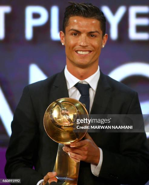 Real Madrid's Portuguese football player Cristiano Ronaldo poses with his "Best Player of the Year" award during the Globe Soccer Awards Ceremony at...