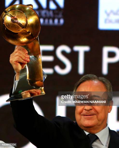 Real Madrid football club's President Florentino Perez holds up his "Best President of the year" award during the Globe Soccer Awards Ceremony at the...