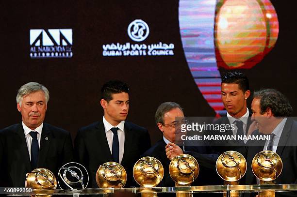 President Michel Platini talks with Real Madrid football club's President Florentino Perez next to Real Madrid's manager Carlo Ancelotti and players...