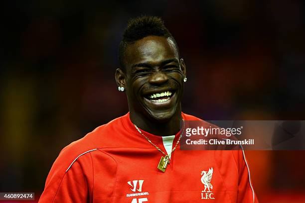 Mario Balotelli of Liverpool laughs during the warm-up for the Barclays Premier League match between Liverpool and Swansea City at Anfield on...