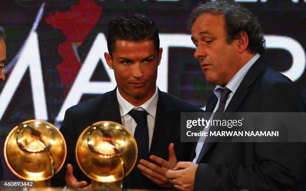 Real Madrid's Portuguese football player Christiano Ronaldo talks with UEFA President Michel Platini after hereceives the "Best Player of the Year"...