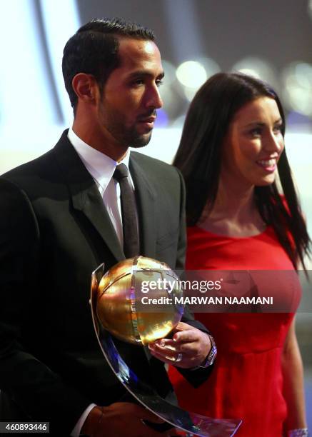 Bayern of Munich's football player Mehdi Benatia holds his "Special" award during the Globe Soccer Awards Ceremony at the end of the 9th...