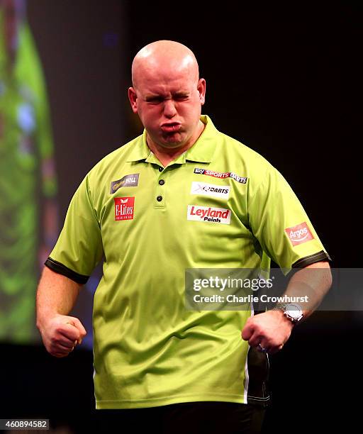 Michael van Gerwen of Holland celebrates winning his third round match against Terry Jenkins of England during the William Hill PDC World Darts...