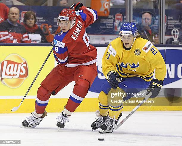 Vladislav Kamenev of Team Russia tries to back check William Nylander of Team Sweden in a 2015 IIHF World Junior Championship game at the Air Canada...