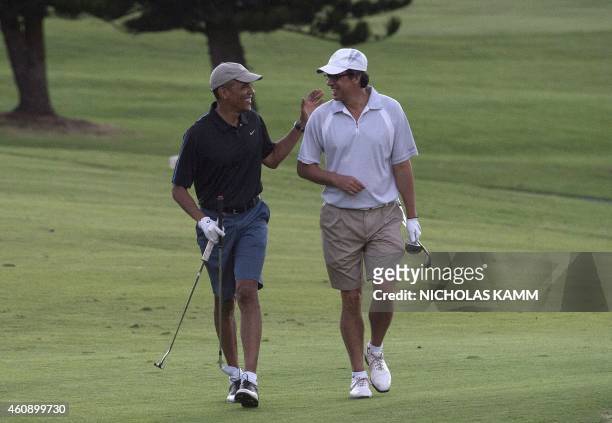 President Barack Obama and Mike Ramos walk to the 18th green as they play golf at the Mid-Pacific Country Club in Kailua on December 30, 2014 . AFP...