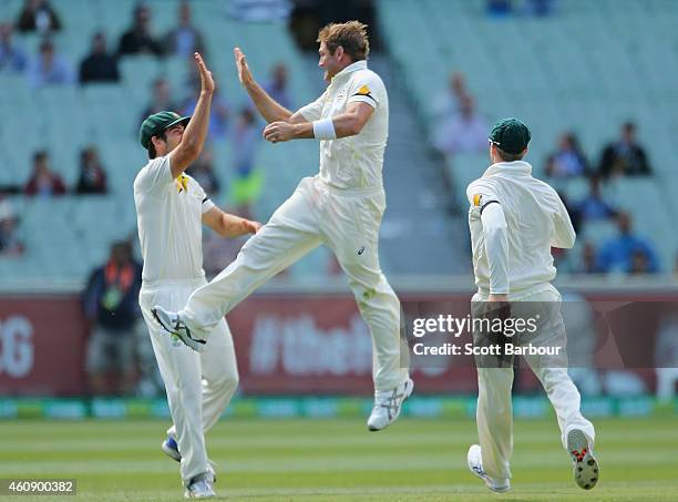 Ryan Harris of Australia celebrates with Joe Burns after dismissing Virat Kohl of India during day five of the Third Test match between Australia and...