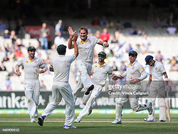 Ryan Harris of Australia celebrates with Joe Burns after dismissing Virat Kohl during day five of the Third Test match between Australia and India at...