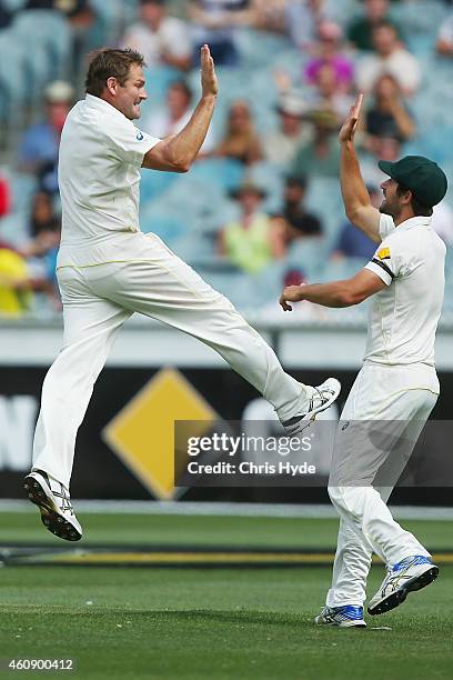 Ryan Harris of Australia celebrates with Joe Burns after taking a catch to dismiss Virat Kohli of India off the bowling of Harris during day five of...