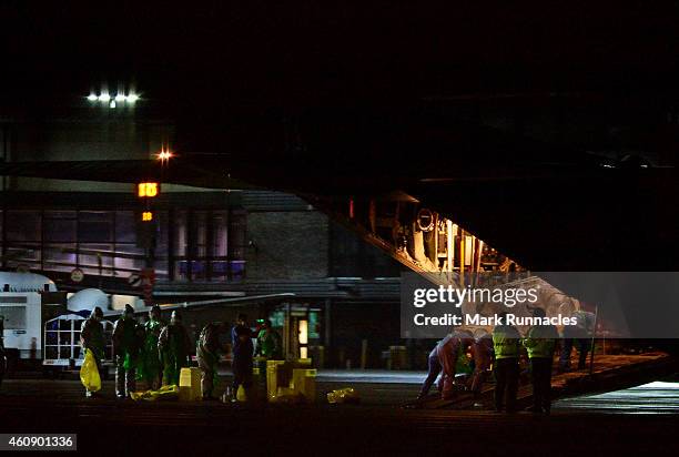 The female healthcare worker who returned from Sierra Leone to Glasgow is taken from an ambulance and loaded onto aircraft at Glasgow International...