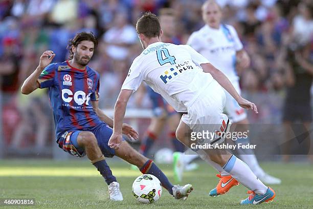Zenon Caravella of the Jets contests the ball against Connor Chapman of Melbourne City during the round 14 A-League match between the Newcastle Jets...