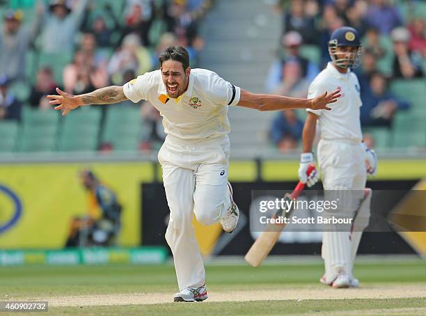 Mitchell Johnson of Australia celebrates after bowling Cheteshwar Pujara of India during day five of the Third Test match between Australia and India...