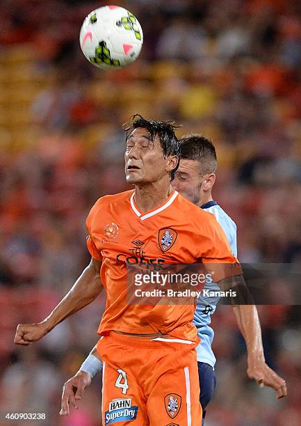 Adam Sarota of the Roar is challenged by Nikola Petkovic of Sydney FC during the round 14 A-League match between the Brisbane Heat and Sydney FC at...