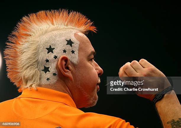 Peter Wright of Scotland shows off his hair style during his third round match against Andy Hamilton of England during the William Hill PDC World...
