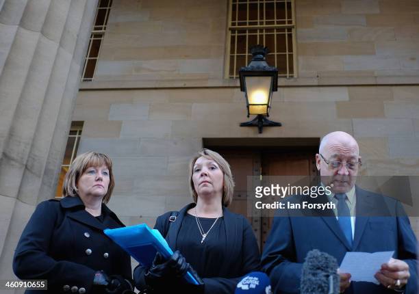 Sisters of PC David Rathband, Julie Reece and Debbie Essery stand next to their father Keith Rathband as he reads a statement to the media at the...