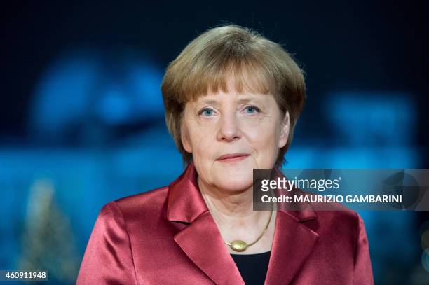 German Chancellor Angela Merkel poses for a photograph after the recording of her annual New Year's speech at the Chancellery in Berlin on December...