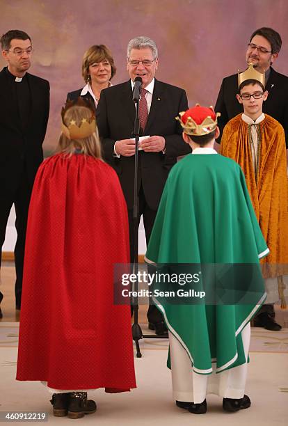 German President Joachim Gauck, flanked by his partner Daniela Schadt, welcomes children Epiphany carolers dressed as the Three Kings at Schloss...