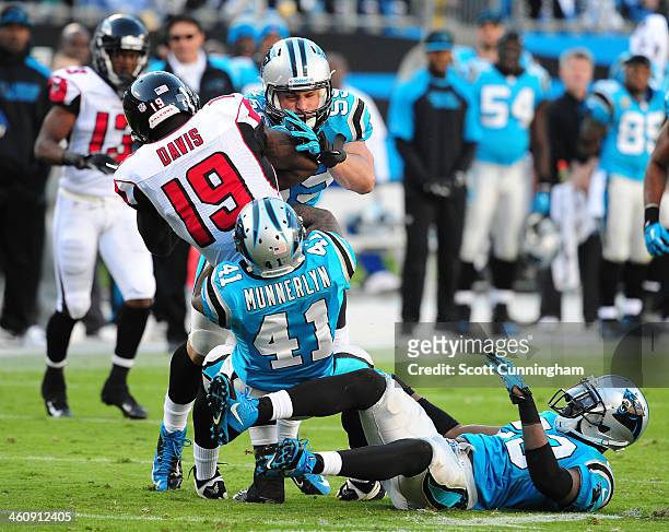 Drew Davis of the Atlanta Falcons is tackled by Captain Munnerlyn and Luke Kuechly of the Carolina Panthers at Bank of America Stadium on November 3,...