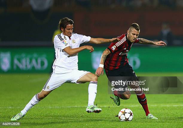 Fabio Coentrao of Real Madrid battles for the ball with Jeremy Menez of AC Milan during the Dubai Football Challenge match between AC Milan and Real...