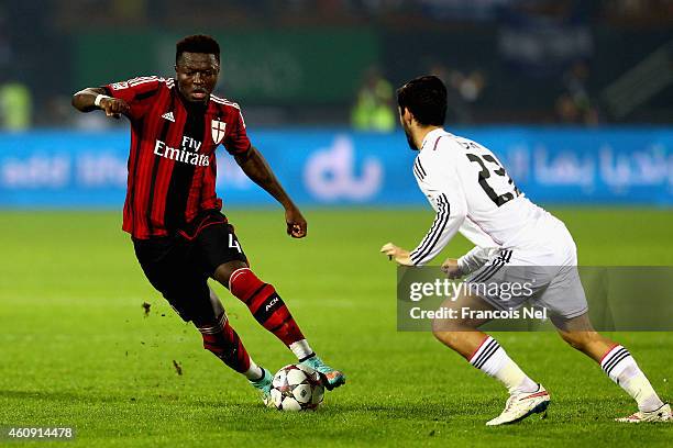 Sulley Ali Muntari of AC Milan holds off Isco of Real Madrid during the Dubai Football Challenge match between AC Milan and Real Madrid at The Sevens...