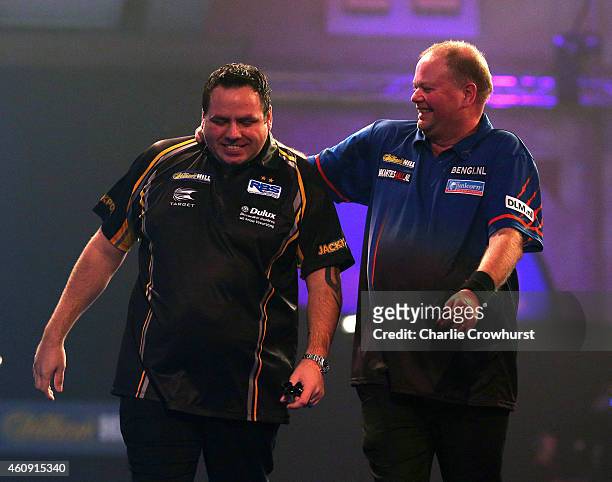 Adrian Lewis of England is congratulated by Raymond van Barneveld of Holland after hitting a nine darter during their third round match during the...