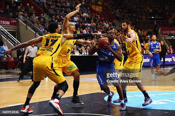 Sean Armand of Frankfurt is challenged by D.J. Kennedy, Shawn Huff and Jon Brockman of Ludwigsburg during the Beko BBL basketball match between MHP...