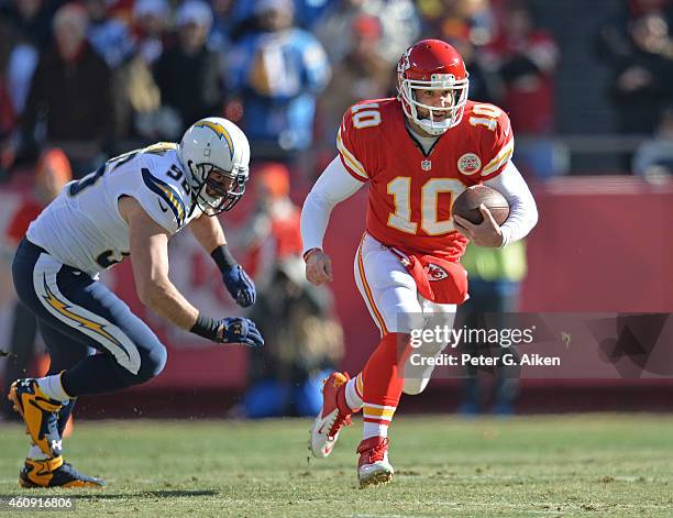 Quarterback Chase Daniel of the Kansas City Chiefs runs up field past linebacker Jarret Johnson of the San Diego Chargers during the first half on...