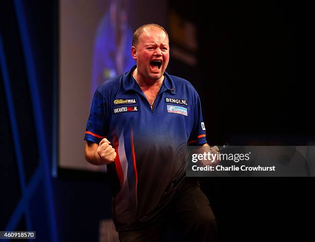 Raymond van Barneveld of Holland celebrates winning his third round match against Adrian Lewis of England during the William Hill PDC World Darts...