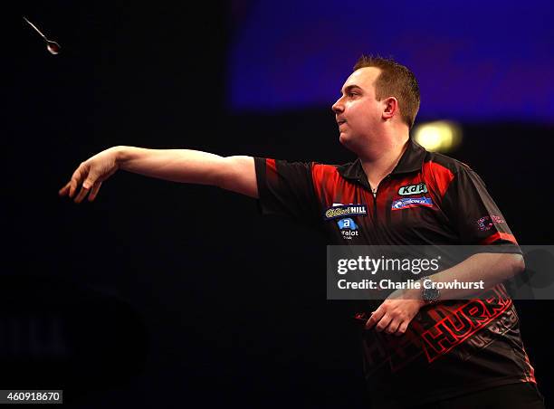 Kim Huybrechts of Belgium in action during his third round match against Phil Taylor of England during the William Hill PDC World Darts Championships...