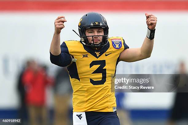 Skyler Howard of the West Virginia Mountaineers celebrates a touchdown against the Texas A&M Aggies during the second quarter of the 56th annual...