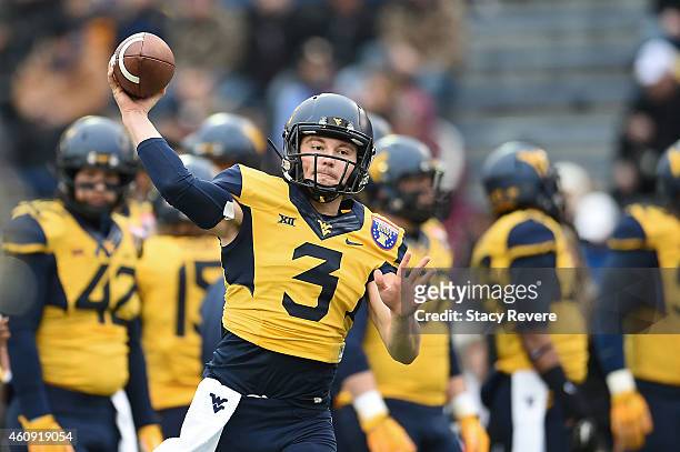 Skyler Howard of the West Virginia Mountaineers participates in warmups prior to the 56th annual Autozone Liberty Bowl against the Texas A&M Aggies...