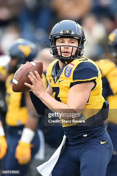 Skyler Howard of the West Virginia Mountaineers participates in warmups prior to the 56th annual Autozone Liberty Bowl against the Texas A&M Aggies...